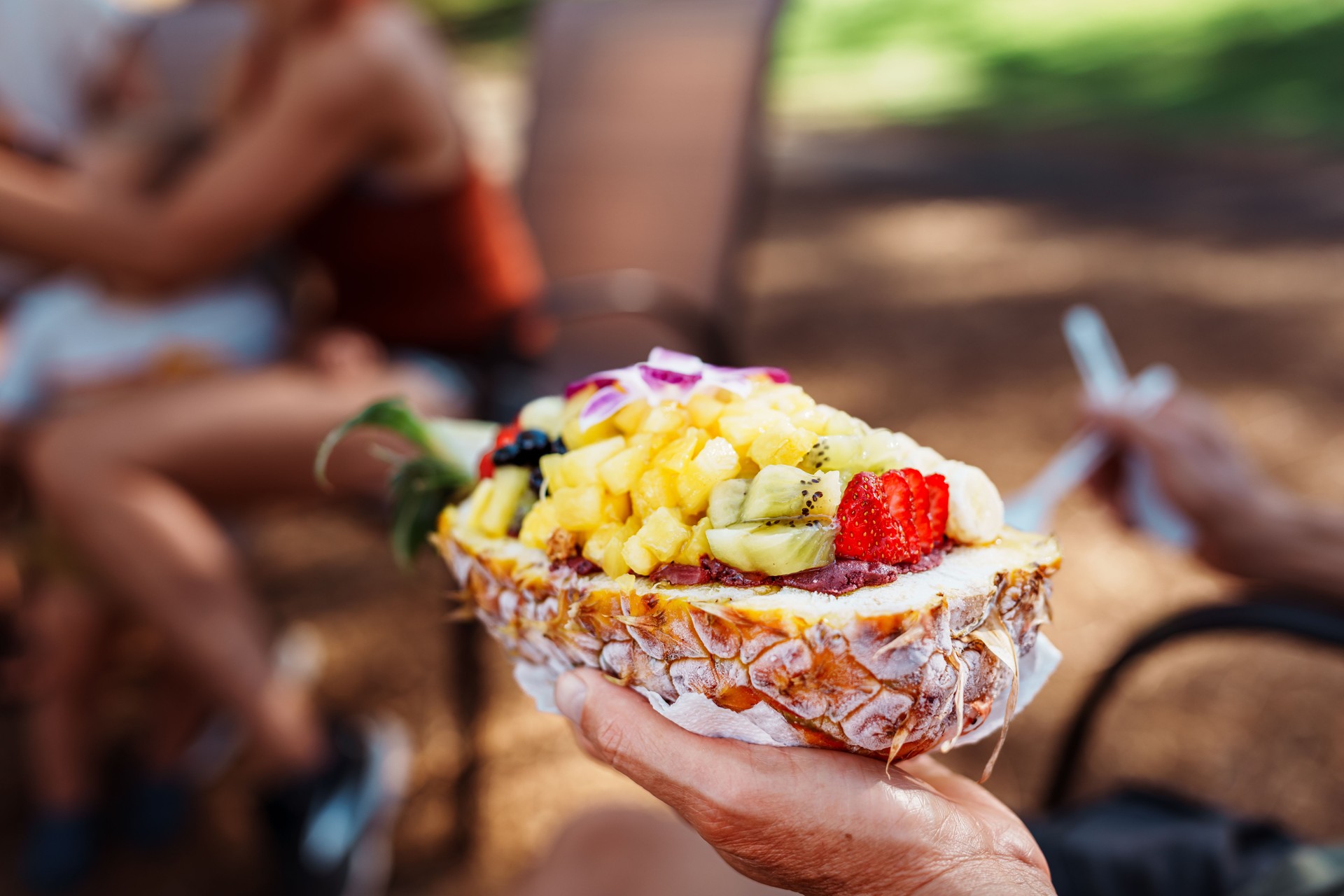 Fresh açaí bowl being held at a picnic